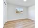 A modern bedroom with wood-look floors, and a window with a pleasant outside view at 303 Suzette Dr, Brandon, FL 33511