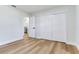 Bright bedroom featuring wood floors, closet, and bathroom entrance, perfect for a cozy retreat at 303 Suzette Dr, Brandon, FL 33511