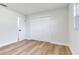 A bright bedroom with light wood flooring, a closet, and a window for natural light at 303 Suzette Dr, Brandon, FL 33511