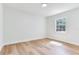 Well-lit bedroom with neutral walls, wood floors, and a large window offering natural light and views at 303 Suzette Dr, Brandon, FL 33511