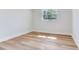 Bedroom with light wood flooring, white walls, a window and light trim at 303 Suzette Dr, Brandon, FL 33511