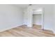 Bedroom with light wood flooring, a closet with folding doors, and a bright window at 303 Suzette Dr, Brandon, FL 33511
