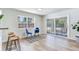 Bright dining area with modern lighting, large windows and sliding glass doors to backyard at 303 Suzette Dr, Brandon, FL 33511