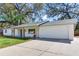 View of the house showing the driveway and the two car garage at 303 Suzette Dr, Brandon, FL 33511