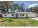 Charming single-story home featuring a well-manicured lawn and welcoming front entrance at 303 Suzette Dr, Brandon, FL 33511