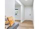 Hallway featuring wood-look floors, white trim, and a gray bench with decorative pillows at 303 Suzette Dr, Brandon, FL 33511