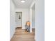Hallway featuring light hardwood flooring and white walls, creating a bright and open space at 303 Suzette Dr, Brandon, FL 33511