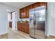 Bright kitchen with stainless steel fridge and wooden cabinets and granite countertop at 303 Suzette Dr, Brandon, FL 33511