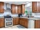 Updated kitchen with stainless steel appliances, granite countertops, and wooden cabinetry at 303 Suzette Dr, Brandon, FL 33511