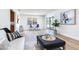 Bright living room featuring an ottoman, modern furnishings, and sliding glass doors to the patio at 303 Suzette Dr, Brandon, FL 33511