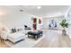 Sunlit living room with stylish decor, including a white sofa and view of kitchen/breakfast nook at 303 Suzette Dr, Brandon, FL 33511