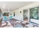 Cozy screened porch with brick floors and inviting furniture, seamlessly blending indoor and outdoor living spaces at 303 Suzette Dr, Brandon, FL 33511