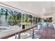 Inviting screened porch with views of the serene backyard, creating a peaceful oasis for relaxation at 303 Suzette Dr, Brandon, FL 33511