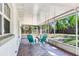 Spacious screened porch with brick floors and views of the expansive backyard, perfect for outdoor enjoyment at 303 Suzette Dr, Brandon, FL 33511