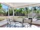 Relaxing screened porch with outdoor seating, offering views of the lush backyard and serene outdoor living at 303 Suzette Dr, Brandon, FL 33511