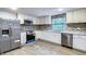 Modern kitchen features stainless steel appliances, granite countertops, and mosaic backsplash at 11201 Blendale Dr, Riverview, FL 33569