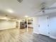 Open floor plan living room leading to kitchen, with new flooring and modern ceiling fans at 11201 Blendale Dr, Riverview, FL 33569