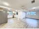 Open floor plan living room leading to kitchen, with new flooring and modern ceiling fans at 11201 Blendale Dr, Riverview, FL 33569