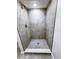 Modern shower featuring gray tiling on the walls and floors, as well as a recessed ceiling light at 11201 Blendale Dr, Riverview, FL 33569
