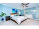 Serene bedroom with blue walls, a wooden headboard, and a bright window with natural light at 114 Laurel Tree Way, Brandon, FL 33511