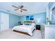 A relaxing bedroom with light blue walls, ceiling fan, and white bedding is the perfect space to unwind at 114 Laurel Tree Way, Brandon, FL 33511