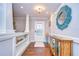 Inviting entryway featuring wood floors, decorative mirror, and a colorful accent cabinet at 114 Laurel Tree Way, Brandon, FL 33511