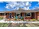 Inviting front porch with seating area and charming details at 114 Laurel Tree Way, Brandon, FL 33511
