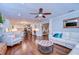 Open-concept living room with hardwood floors, white sofas, and access to a modern kitchen at 114 Laurel Tree Way, Brandon, FL 33511