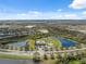 Aerial view of the community with a pool, park, ponds, and lush landscaping at 11544 Brighton Knoll Loop, Riverview, FL 33579