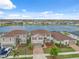 Aerial view of a lakeside home with brick driveway and proximity to community amenities and beautiful water at 11544 Brighton Knoll Loop, Riverview, FL 33579