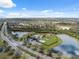 Aerial view showcasing the community with mature trees, lakes and community playground at 11544 Brighton Knoll Loop, Riverview, FL 33579