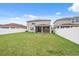 View of the green backyard featuring a screened patio and a well-maintained lawn at 11544 Brighton Knoll Loop, Riverview, FL 33579