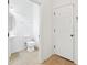 View of a half bath with tile floors, white toilet and sink at 11544 Brighton Knoll Loop, Riverview, FL 33579