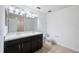 Bathroom with dual sinks, granite countertop, and dark cabinetry at 11544 Brighton Knoll Loop, Riverview, FL 33579