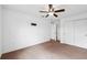 This is a carpeted bedroom featuring a ceiling fan and closet for storage at 11544 Brighton Knoll Loop, Riverview, FL 33579