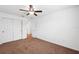 This is a simple carpeted bedroom featuring a ceiling fan and closet for storage at 11544 Brighton Knoll Loop, Riverview, FL 33579