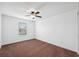 This is a simple carpeted bedroom featuring a ceiling fan and a window at 11544 Brighton Knoll Loop, Riverview, FL 33579