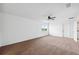 Spacious bedroom with neutral carpet, ceiling fan, and a large window overlooking the outside at 11544 Brighton Knoll Loop, Riverview, FL 33579