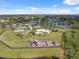 An aerial view showcases a playground with a pool and pond in a well-kept community park at 11544 Brighton Knoll Loop, Riverview, FL 33579