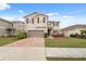 Well-maintained two-story home with a brick driveway, attached two-car garage, and neat front lawn at 11544 Brighton Knoll Loop, Riverview, FL 33579