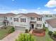 Attractive two-story home showcasing a brick driveway, manicured landscaping, and an attached two-car garage at 11544 Brighton Knoll Loop, Riverview, FL 33579