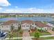 Aerial front view of homes with manicured lawns, brick driveways and a serene lake backdrop at 11544 Brighton Knoll Loop, Riverview, FL 33579