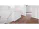Upstairs hallway with carpet, white walls, and an open doorway to another room at 11544 Brighton Knoll Loop, Riverview, FL 33579