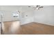 Spacious living room featuring wood flooring, large windows for natural light, and modern ceiling fans at 11544 Brighton Knoll Loop, Riverview, FL 33579