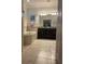 Relaxing bathroom features a soaking tub, dual sink vanity with dark cabinets, and neutral tile flooring at 11648 Palmetto Pine St, Riverview, FL 33569