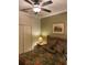 Cozy bedroom with ceiling fan, olive accent wall, traditional furnishings, and closet at 11648 Palmetto Pine St, Riverview, FL 33569