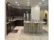 Elegant kitchen with stainless steel appliances, granite countertops, tile floors, and a breakfast bar at 11648 Palmetto Pine St, Riverview, FL 33569