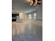 Open-concept living space featuring tile floors, plantation shutters, and seamless flow to the modern kitchen at 11648 Palmetto Pine St, Riverview, FL 33569