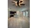 Expansive living area with tile flooring, modern lighting fixtures, and easy access to the kitchen at 11648 Palmetto Pine St, Riverview, FL 33569