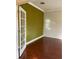 Bright office space featuring hardwood floors, neutral walls, and glass French doors at 11648 Palmetto Pine St, Riverview, FL 33569